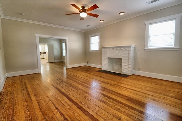 3704 5th St, Brookshire, TX 77423 - unfurnished living room with a ceiling fan, wood-type flooring, crown molding, a fireplace, and baseboards