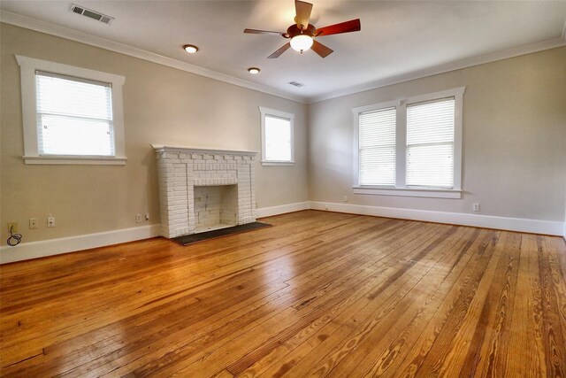 3704 5th St, Brookshire, TX 77423 - unfurnished living room with a ceiling fan, wood-type flooring, ornamental molding, and baseboards