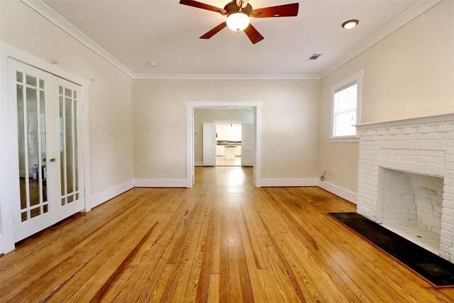 3704 5th St, Brookshire, TX 77423 - unfurnished living room featuring ceiling fan, light wood-style flooring, baseboards, crown molding, and a fireplace