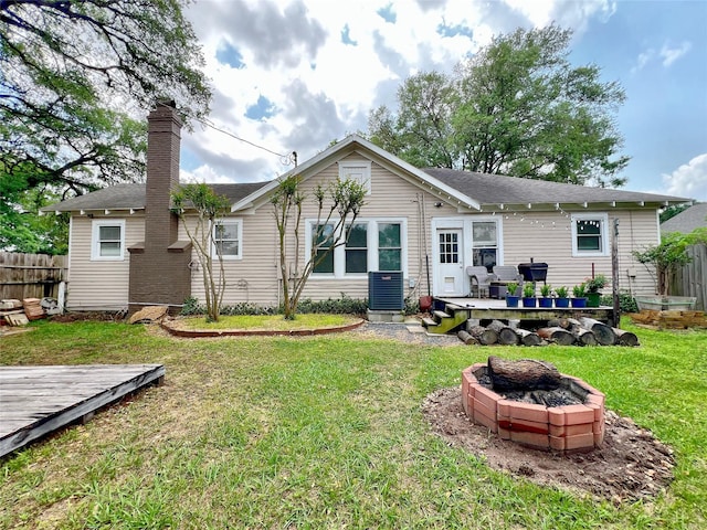 3704 5th St, Brookshire, TX 77423 - back of house with a wooden deck, a fire pit, a chimney, and central AC unit