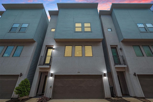 953 Saint Augustine St, Houston, TX 77023 - multi unit property featuring an attached garage, stucco siding, driveway, and a balcony