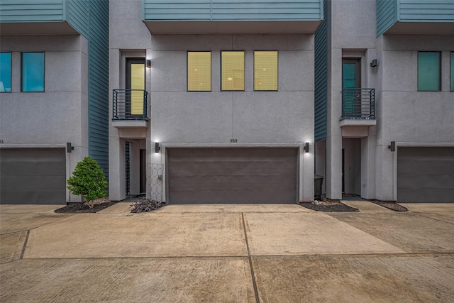 953 Saint Augustine St, Houston, TX 77023 - townhome / multi-family property with a garage, concrete driveway, and stucco siding