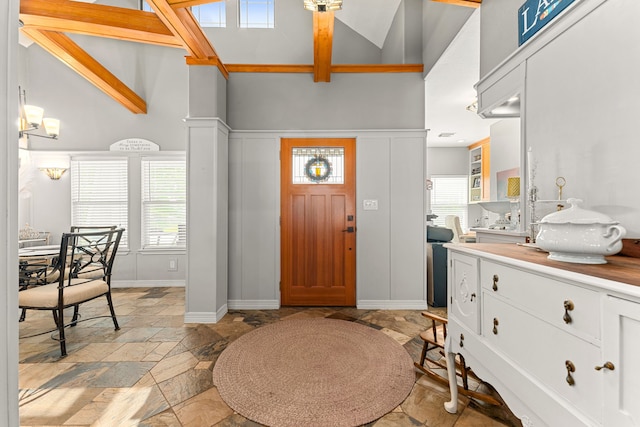 12596 Point Aquarius Blvd, Willis, TX 77318 - foyer featuring high vaulted ceiling, stone tile flooring, and baseboards