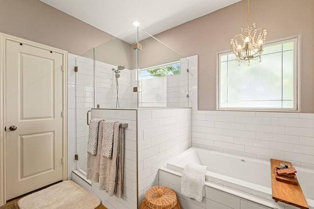 12596 Point Aquarius Blvd, Willis, TX 77318 - full bathroom with a shower stall, a garden tub, and a chandelier