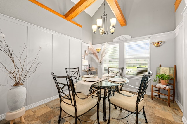 12596 Point Aquarius Blvd, Willis, TX 77318 - dining area with high vaulted ceiling, stone tile floors, a chandelier, beam ceiling, and baseboards