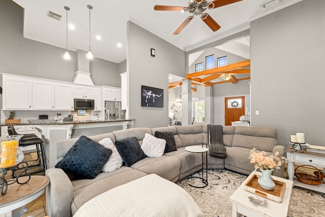 12596 Point Aquarius Blvd, Willis, TX 77318 - living room with high vaulted ceiling, a ceiling fan, ornate columns, and ornamental molding
