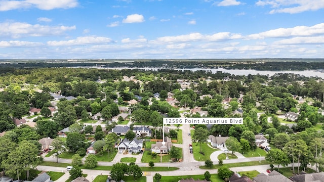 12596 Point Aquarius Blvd, Willis, TX 77318 - aerial view of property and surrounding area with a large body of water and nearby suburban area