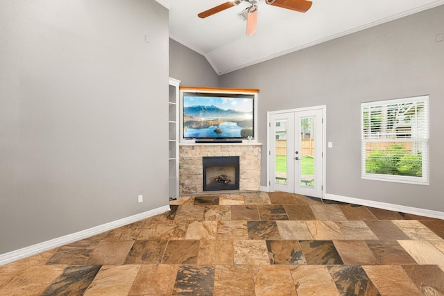 12596 Point Aquarius Blvd, Willis, TX 77318 - unfurnished living room with ornamental molding, stone tile flooring, ceiling fan, baseboards, and a stone fireplace