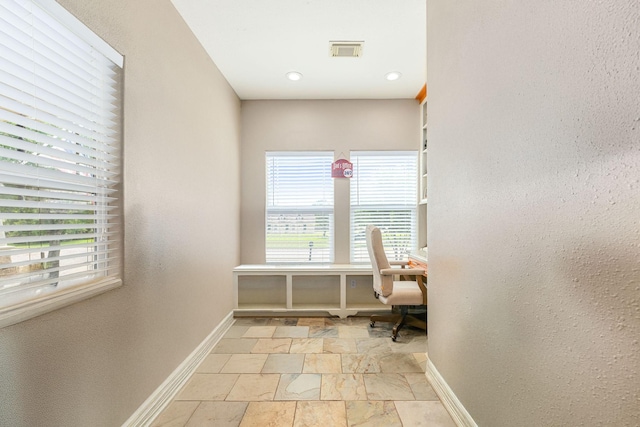 12596 Point Aquarius Blvd, Willis, TX 77318 - sitting room with stone tile floors, baseboards, an office area, and a textured wall