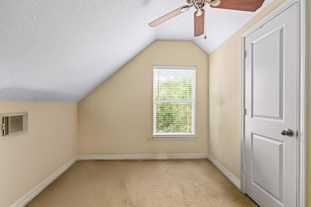 12596 Point Aquarius Blvd, Willis, TX 77318 - bonus room featuring ceiling fan, lofted ceiling, baseboards, light carpet, and a textured ceiling