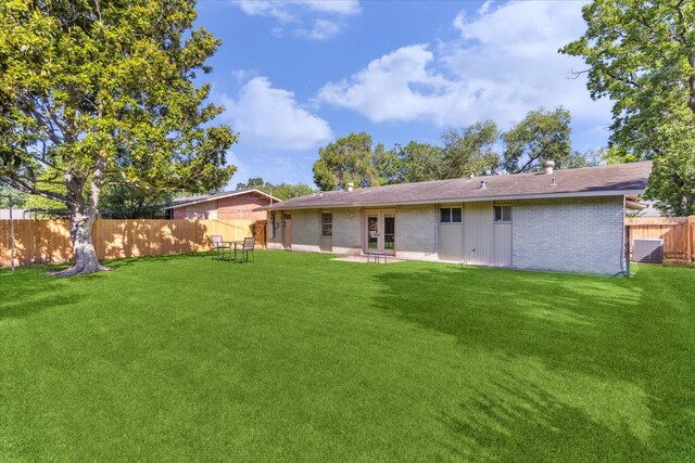 9547 Beverlyhill St, Houston, TX 77063 - rear view of house featuring central AC unit, brick siding, a patio, and roof with shingles