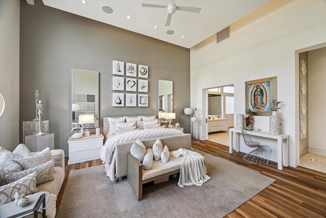 311 Brown Saddle St, Houston, TX 77057 - bedroom with a towering ceiling, wood finished floors, baseboards, ensuite bath, and ceiling fan