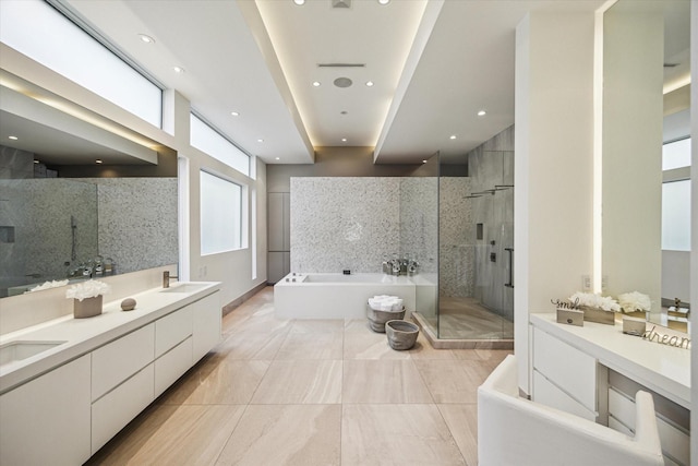 311 Brown Saddle St, Houston, TX 77057 - full bathroom featuring a shower stall, a bath, double vanity, recessed lighting, and tile patterned floors