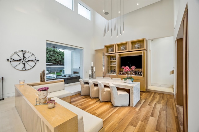 311 Brown Saddle St, Houston, TX 77057 - living room with healthy amount of natural light, a high ceiling, light wood finished floors, and recessed lighting