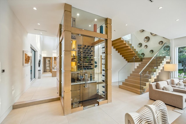 311 Brown Saddle St, Houston, TX 77057 - wine cellar with recessed lighting, light tile patterned flooring, and bar
