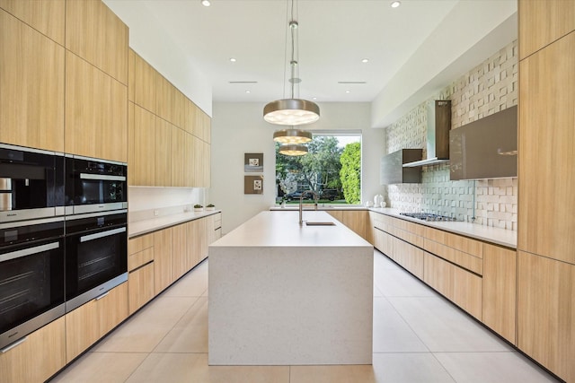 311 Brown Saddle St, Houston, TX 77057 - kitchen with modern cabinets, wall chimney exhaust hood, backsplash, gas stovetop, and recessed lighting