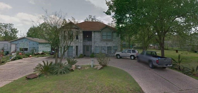 5407 Victoria Dr, Rosharon, TX 77583 - view of front facade with stone siding and a front lawn