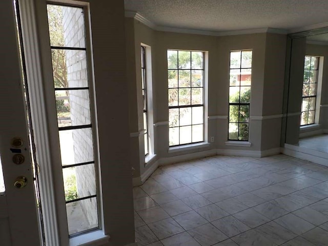 5407 Victoria Dr, Rosharon, TX 77583 - entryway with baseboards, a textured ceiling, marble finish flooring, and ornamental molding