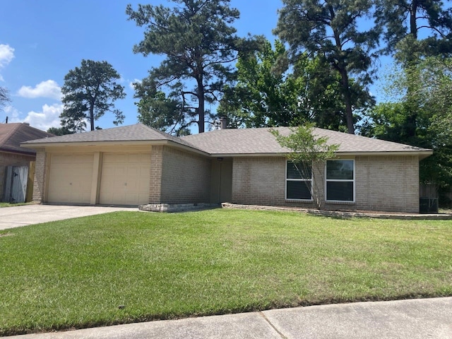 8315 Marble Arch Ct, Humble, TX 77338 - view of front of property with brick siding, a front lawn, a garage, and driveway