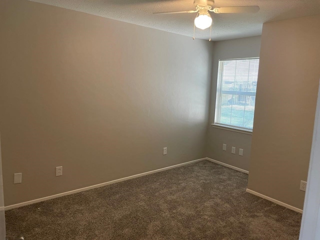 8315 Marble Arch Ct, Humble, TX 77338 - spare room with dark carpet, ceiling fan, a textured ceiling, and baseboards