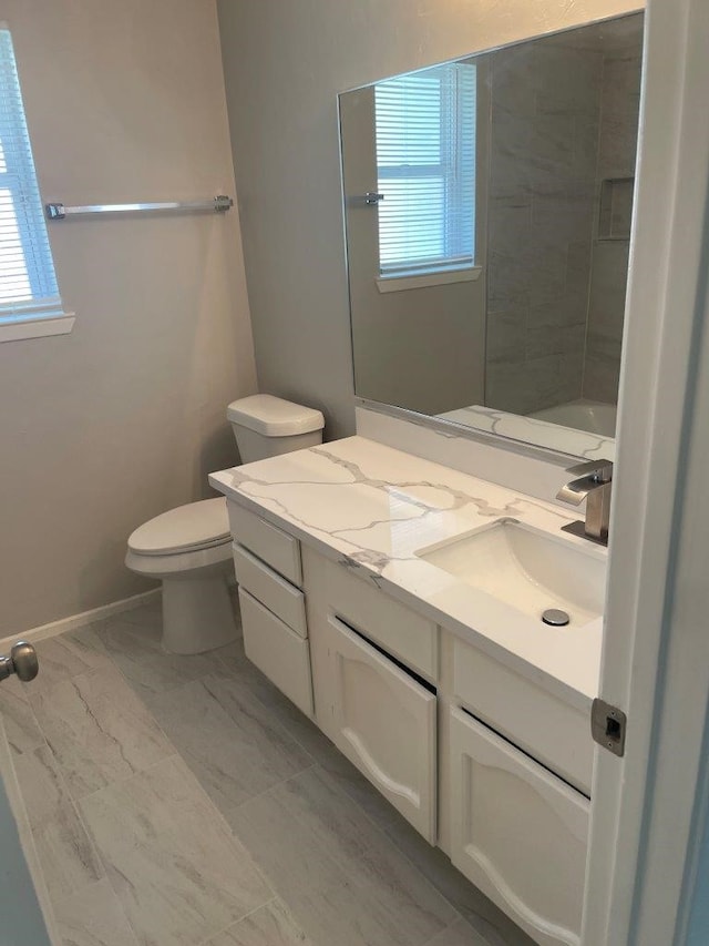 8315 Marble Arch Ct, Humble, TX 77338 - full bathroom featuring vanity, toilet, marble finish floors, and baseboards