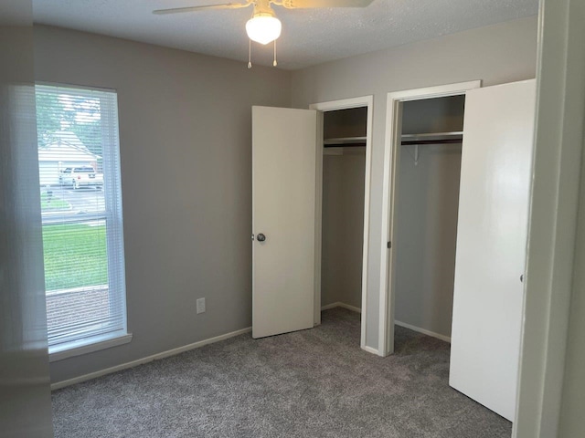 8315 Marble Arch Ct, Humble, TX 77338 - unfurnished bedroom featuring multiple closets, carpet flooring, baseboards, and a ceiling fan