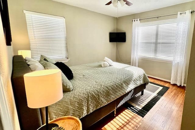 715 S Nugent St, La Porte, TX 77571 - bedroom with wood finished floors, baseboards, and a ceiling fan