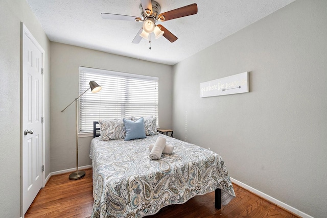 715 S Nugent St, La Porte, TX 77571 - bedroom with baseboards, wood finished floors, and ceiling fan