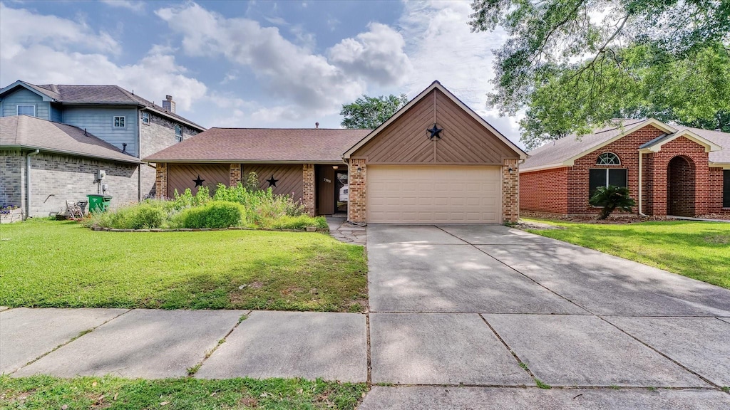 23938 Spring Way Dr, Spring, TX 77373 - view of front of property featuring an attached garage, driveway, a front yard, and brick siding