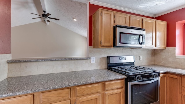 23938 Spring Way Dr, Spring, TX 77373 - kitchen with appliances with stainless steel finishes, backsplash, a textured ceiling, ceiling fan, and vaulted ceiling