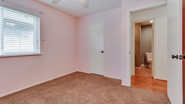 23938 Spring Way Dr, Spring, TX 77373 - unfurnished bedroom with carpet, a closet, baseboards, a ceiling fan, and a textured ceiling