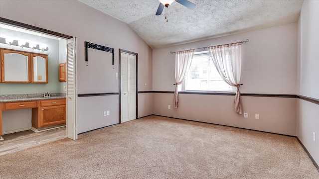 23938 Spring Way Dr, Spring, TX 77373 - unfurnished bedroom featuring lofted ceiling, light colored carpet, ensuite bathroom, a textured ceiling, and ceiling fan
