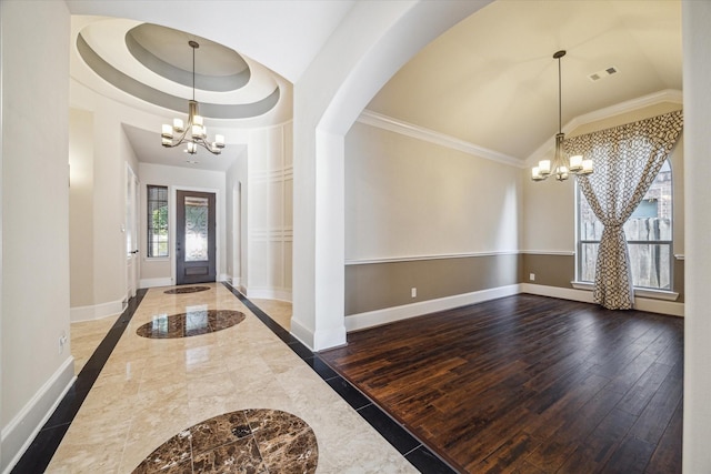 7930 Rippling Stream Ln, Richmond, TX 77407 - entryway featuring a chandelier, inlaid floor details, baseboards, crown molding, and vaulted ceiling