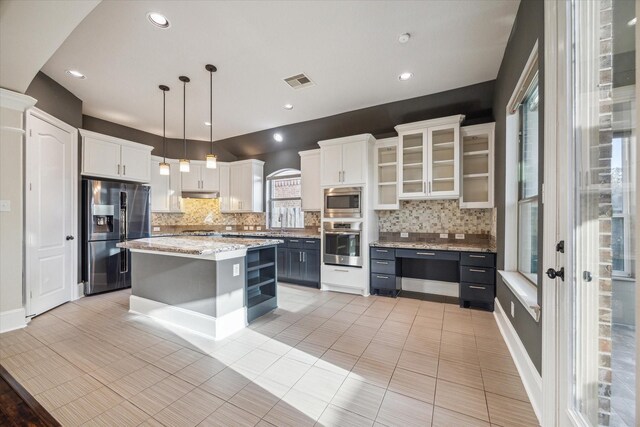 7930 Rippling Stream Ln, Richmond, TX 77407 - kitchen with appliances with stainless steel finishes, backsplash, white cabinets, and recessed lighting