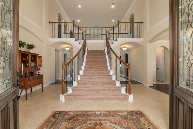11702 Saporito Way, Richmond, TX 77406 - entrance foyer with arched walkways, a high ceiling, baseboards, stairway, and recessed lighting