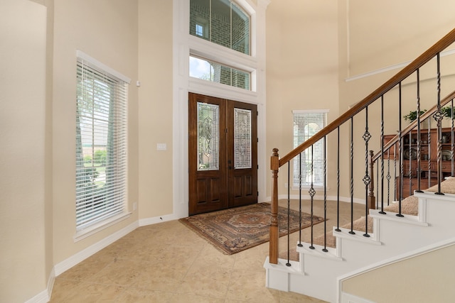 11702 Saporito Way, Richmond, TX 77406 - foyer with a high ceiling, stairs, baseboards, and tile patterned floors