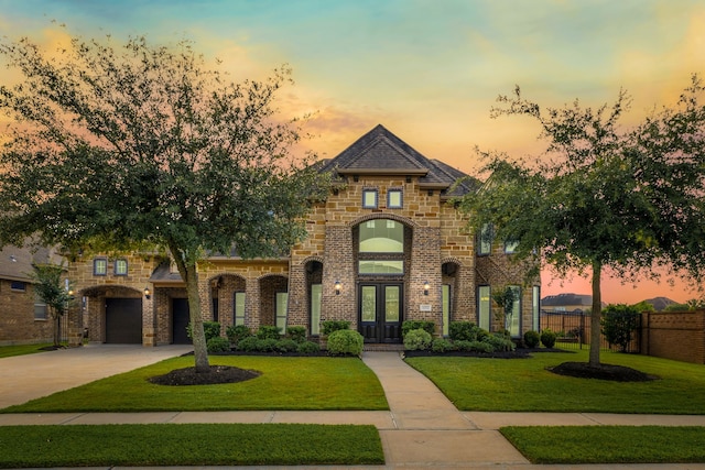 11702 Saporito Way, Richmond, TX 77406 - french country inspired facade featuring french doors, driveway, brick siding, and a garage