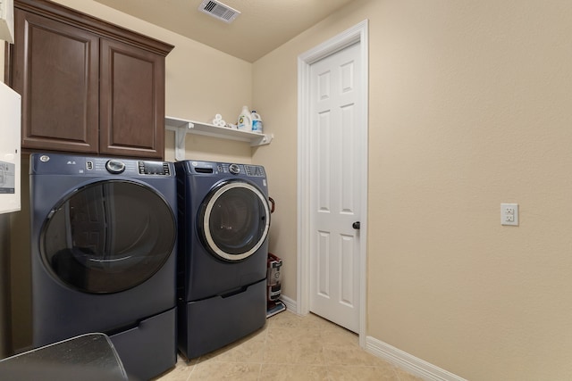 11702 Saporito Way, Richmond, TX 77406 - washroom featuring washing machine and dryer, cabinet space, baseboards, and light tile patterned floors