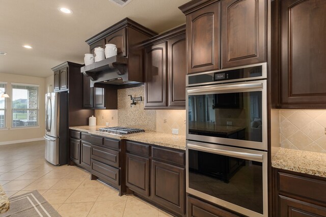 11702 Saporito Way, Richmond, TX 77406 - kitchen featuring stainless steel appliances, dark brown cabinets, decorative backsplash, light stone countertops, and recessed lighting