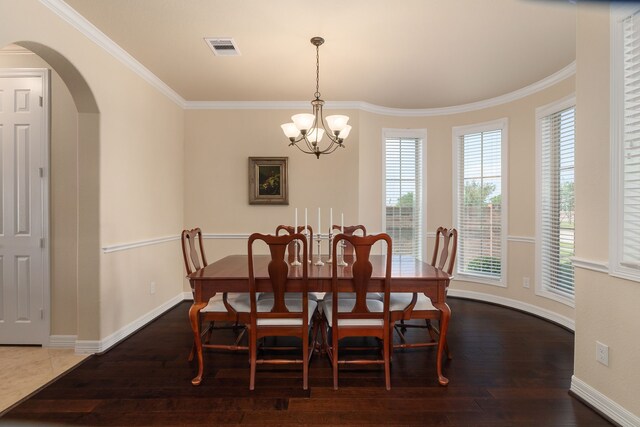 11702 Saporito Way, Richmond, TX 77406 - dining room featuring ornamental molding, arched walkways, a chandelier, wood finished floors, and plenty of natural light