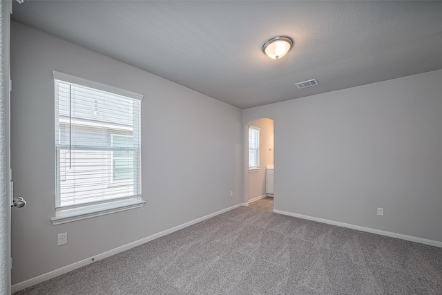 230 Emerald Thicket Ln, Huffman, TX 77336 - carpeted spare room with arched walkways and baseboards