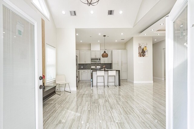 8125 Kenton St, Houston, TX 77028 - kitchen with stainless steel appliances, a kitchen island with sink, open floor plan, tasteful backsplash, and recessed lighting