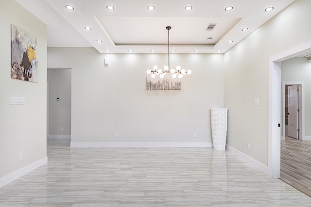 8125 Kenton St, Houston, TX 77028 - empty room with recessed lighting, a chandelier, baseboards, and a raised ceiling