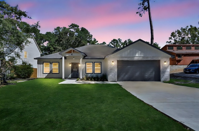 4 Hanover Ln, Panorama Village, TX 77304 - view of front facade featuring an attached garage, driveway, a lawn, and board and batten siding