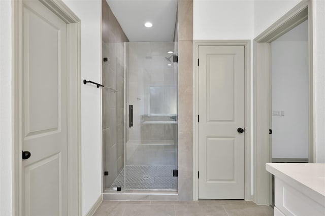 4 Hanover Ln, Panorama Village, TX 77304 - bathroom featuring a stall shower, tile patterned floors, vanity, and recessed lighting