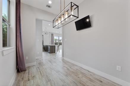 1804 Schweikhardt St, Houston, TX 77020 - unfurnished dining area featuring wood finished floors, a chandelier, baseboards, and recessed lighting