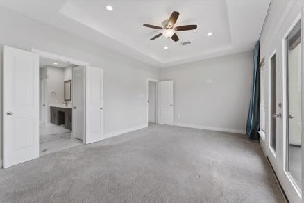 1804 Schweikhardt St, Houston, TX 77020 - unfurnished bedroom featuring a raised ceiling, recessed lighting, carpet, ensuite bathroom, and baseboards