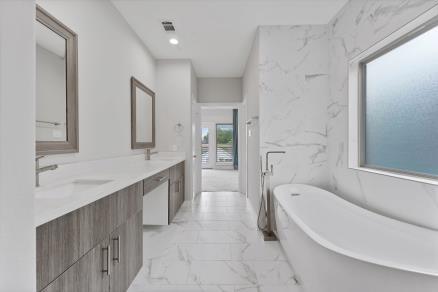 1804 Schweikhardt St, Houston, TX 77020 - full bathroom with marble finish flooring, a freestanding tub, and double vanity