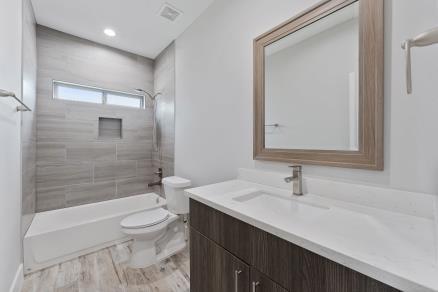1804 Schweikhardt St, Houston, TX 77020 - full bathroom with vanity, toilet, bathtub / shower combination, and recessed lighting