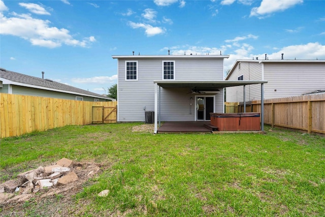 19826 Creston Cove Ct, Cypress, TX 77433 - back of house with a hot tub, a ceiling fan, and cooling unit